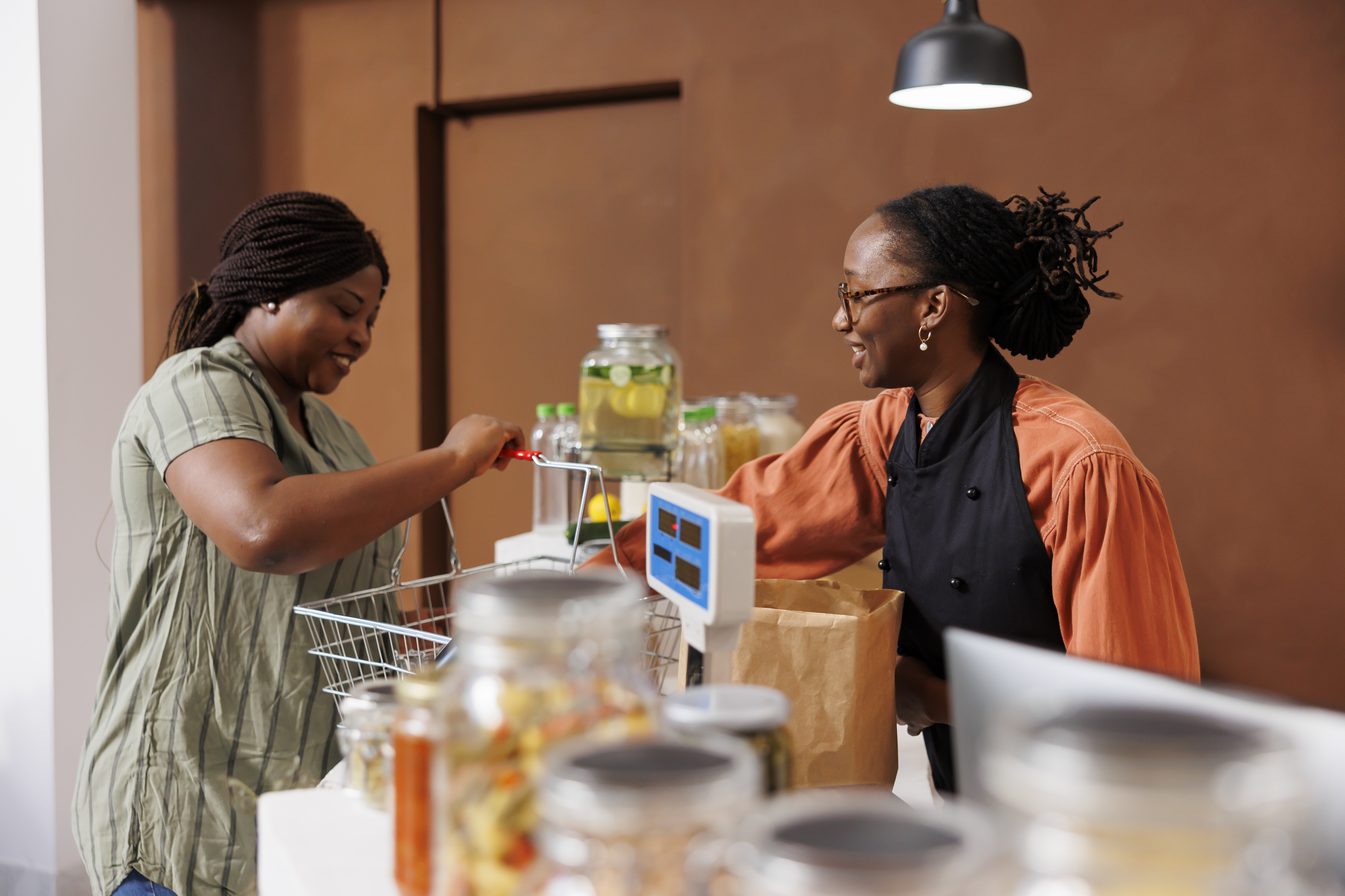 Vendor smiling and engaging warmly with a customer at their shop or booth.