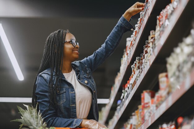 A picture of a successful business owner restocking her store.